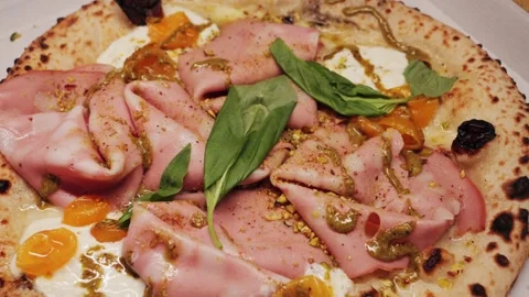 Delicious pizza with prosciutto parma ham, spinach and sun-dried tomatoes. Stock Footage 310827149