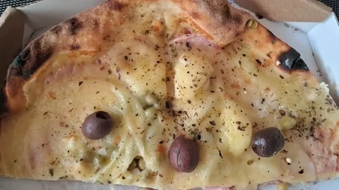 Delicious pizza slice with olives and herbs in motion video Stock Footage 338134654