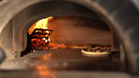 Delicious pizzas baking in hot burning oven Stock Footage 241484324