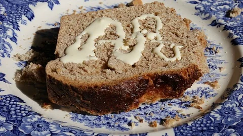 Delicious plain cake is being poured with cream. White sauce dripping on dessert Stock Footage 74897861