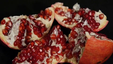 Delicious pomegranate. Portion of fresh made pomegranate isolated on a black 스톡 동영상 106205346