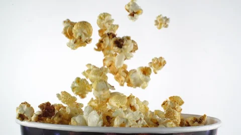 Delicious popcorn falling into a box in slow motion Video stock 105599548