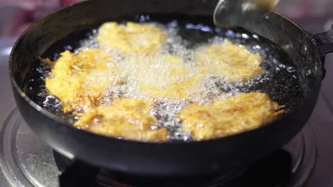 Delicious potato bondas being deep fried to a crispy texture Stock Footage 332110157
