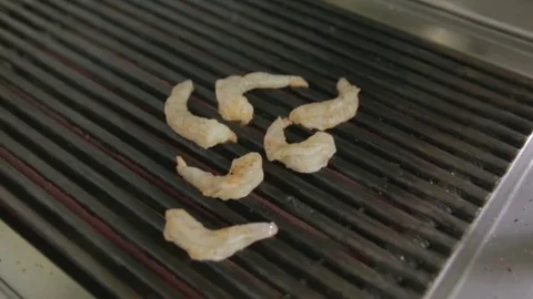 Delicious prawn spit on grill with flames in background Video stock 81431809