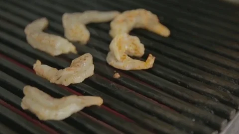 Delicious prawn spit on grill with flames in background Video stock 81431973