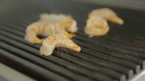 Delicious prawn spit on grill with flames in background Stock Footage 81432093