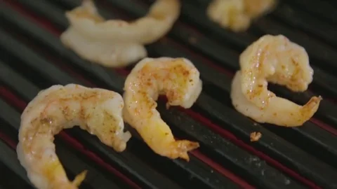 Delicious prawn spit on grill with flames in background Video stock 81432173