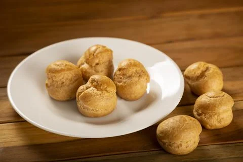 Delicious profiteroles on the table. Stock Photos