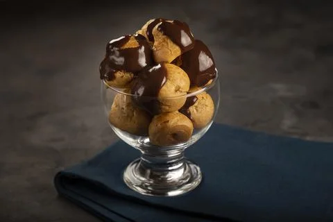 Delicious profiteroles on the table. Stock Photos