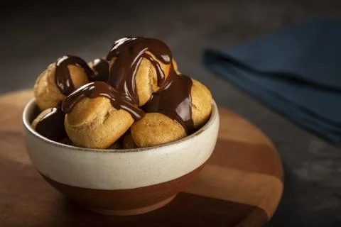 Delicious profiteroles on the table. Stock Photos