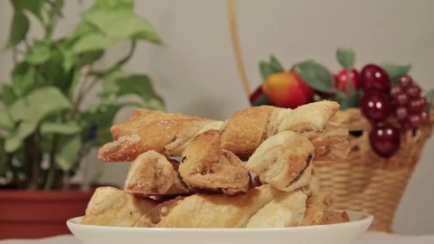 Delicious puff cookie rotate on the background of flowers Stock Footage 69885418