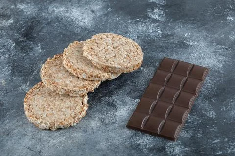 Delicious puffed rice bread with bar of chocolate Stock Photos