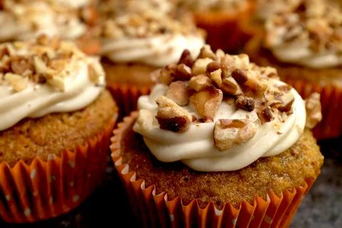 Delicious pumpkin muffins with icing and nuts Stock Photos