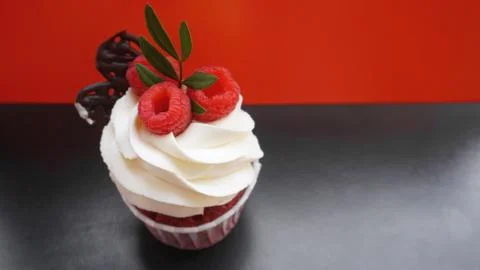 Delicious raspberry cupcakes on dark background Stock Photos