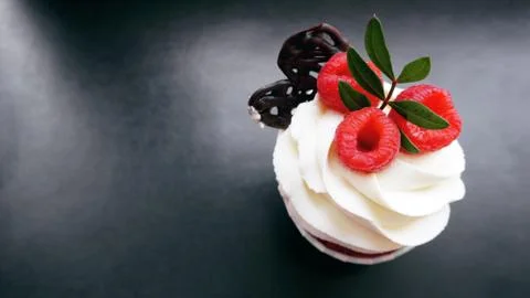 Delicious raspberry cupcakes on dark background Stock Photos