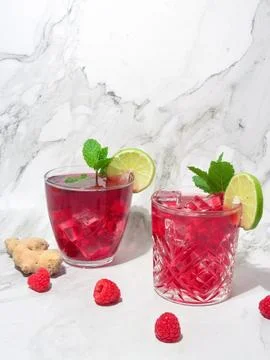 Delicious raspberry, lime and ginger drink on a marble background Stock Photos