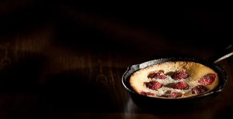 Delicious Raspberry pancake in cast iron pan Stock Photos
