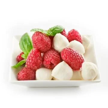 Delicious raspberry salad with mozarella and basil Stock Photos