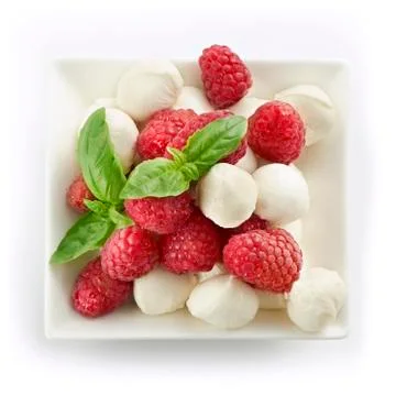 Delicious raspberry salad with mozarella and basil Stock Photos
