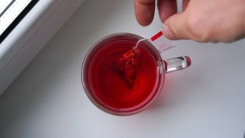Delicious raspberry tea brewed in big glass cup upper view Stock Footage 117961631