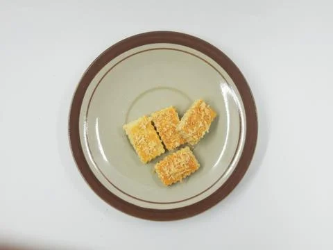 Delicious rectangular cheese cookies served on a vintage ceramic plate Stock Photos