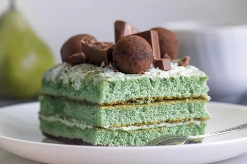 Delicious rectangular green cake on a white plate Stock Photos