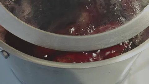 Delicious red beetroot soup, or borscht, boiling and simmering in a saucepan Stockbeeldmateriaal 347464857