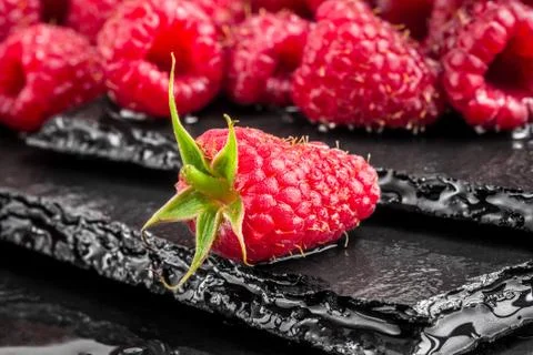 Delicious red raspberry on a slate table Stock Photos
