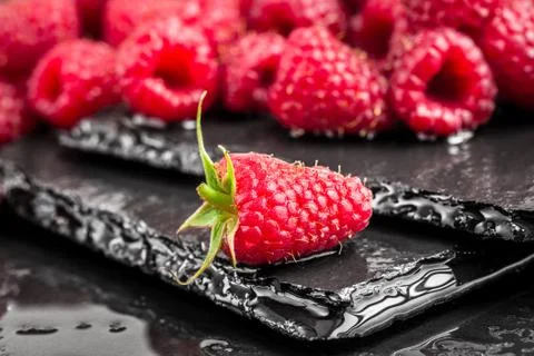 Delicious red raspberry on a slate table Stock Photos