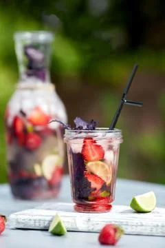 Delicious refreshing lemonade with basil, lime and strawberries Stock Photos