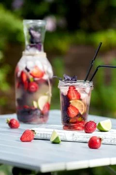 Delicious refreshing lemonade with basil, lime and strawberries Stock Photos