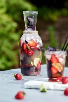 Delicious refreshing lemonade with basil, lime and strawberries Stock Photos