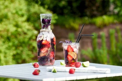 Delicious refreshing lemonade with basil, lime and strawberries Stock Photos