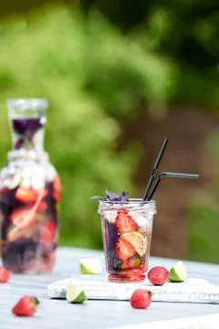 Delicious refreshing lemonade with basil, lime and strawberries Stock Photos