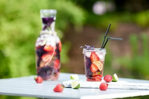 Delicious refreshing lemonade with basil, lime and strawberries Stock Photos
