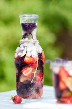 Delicious refreshing lemonade with basil, lime and strawberries Stock Photos