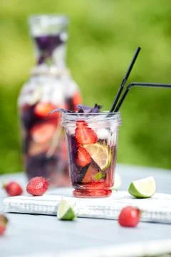 Delicious refreshing lemonade with basil, lime and strawberries Stock Photos