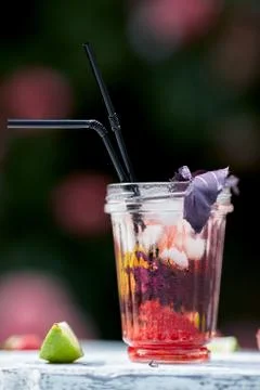 Delicious refreshing lemonade with basil, lime and strawberries Stock Photos