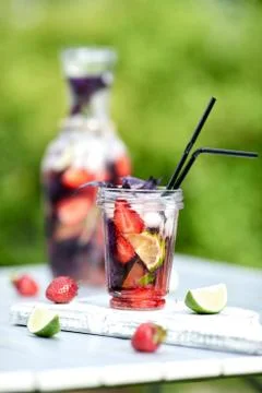 Delicious refreshing lemonade with basil, lime and strawberries Stock Photos