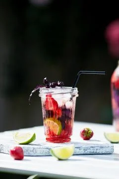 Delicious refreshing lemonade with basil, lime and strawberries Stock Photos