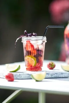 Delicious refreshing lemonade with basil, lime and strawberries Stock Photos