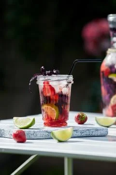 Delicious refreshing lemonade with basil, lime and strawberries Stock Photos