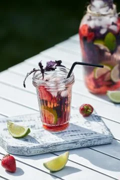 Delicious refreshing lemonade with basil, lime and strawberries Stock Photos
