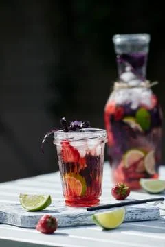 Delicious refreshing lemonade with basil, lime and strawberries Stock Photos