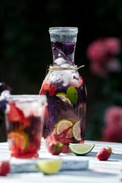 Delicious refreshing lemonade with basil, lime and strawberries Stock Photos