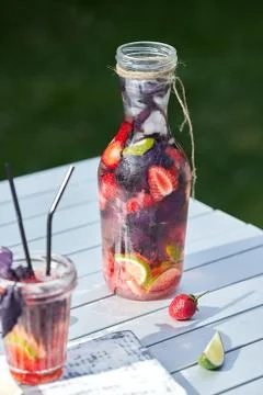 Delicious refreshing lemonade with basil, lime and strawberries Stock Photos