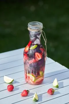 Delicious refreshing lemonade with basil, lime and strawberries Stock Photos