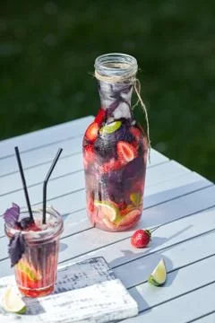 Delicious refreshing lemonade with basil, lime and strawberries Stock Photos