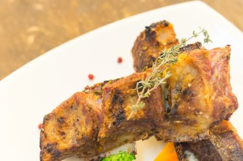 Delicious rib steak and vegetables placed on white plate, elegant presentation 스톡 사진