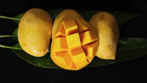 Delicious ripe mango prepared in hedgehog cut style with natural green leaf Stock Footage 337140769